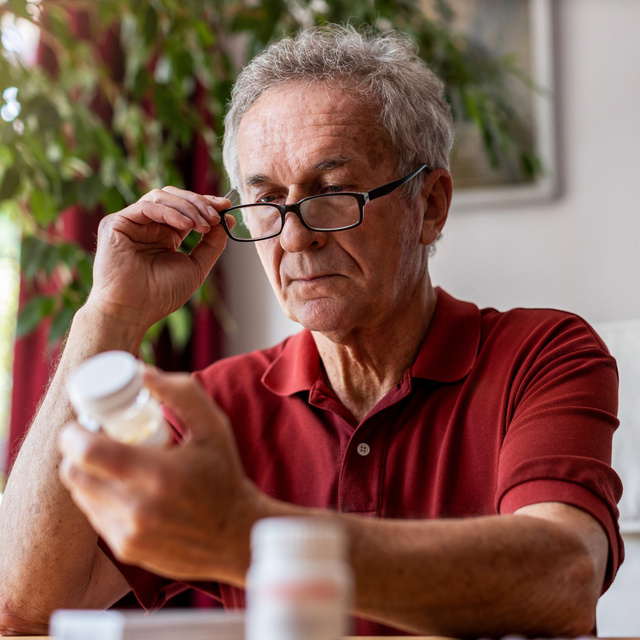 man inspecting medication